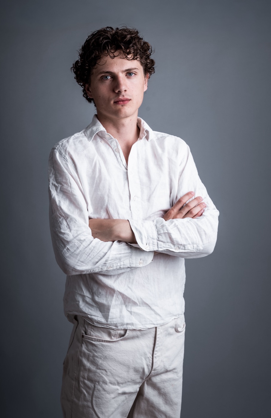 William Jannert: portrait in a white shirt, arms crossed